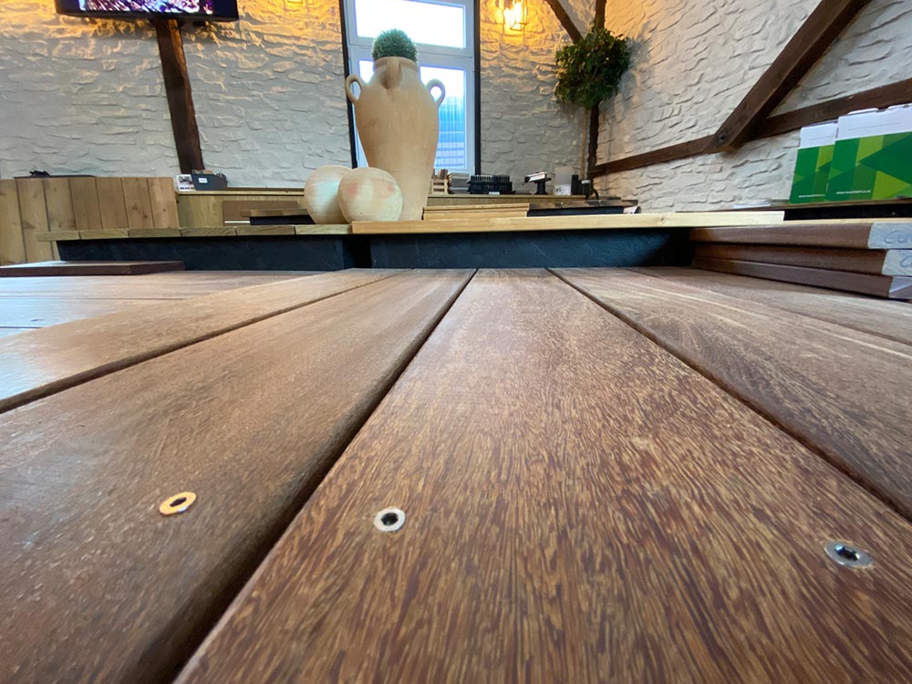 Terrassendielen aus Holz glatt und geriffelt bei Himmel & Weiss Nahaufnahme glatter Holzterrassendielen in der Ausstellung von Himmel & Weiss